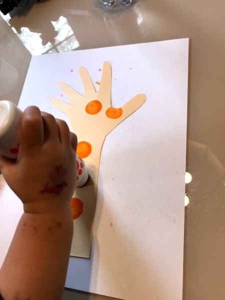 Handprint Giraffe Bookmark - child using a dot marker