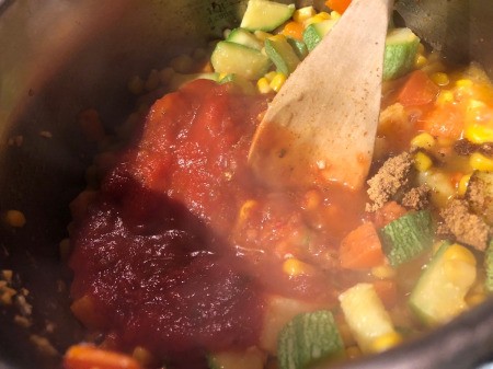 adding sauce to Stew