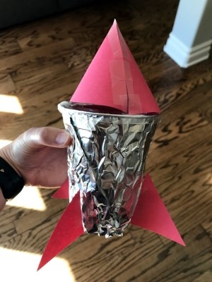 Rocket Ship Party Favor Cups - child's hand holding the completed cup