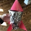 Rocket Ship Party Favor Cups - child's hand holding the completed cup