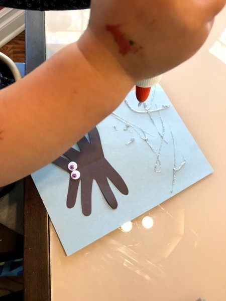 Spider Handprint Craft - glue down to a piece of paper and allow child to paint web using glitter glue