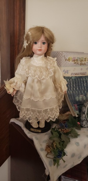 Identifying a Porcelain Doll - doll wearing a lace trimmed off-white dress