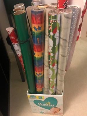 Long rolls of wrapping paper stored in a recycled cardboard box.