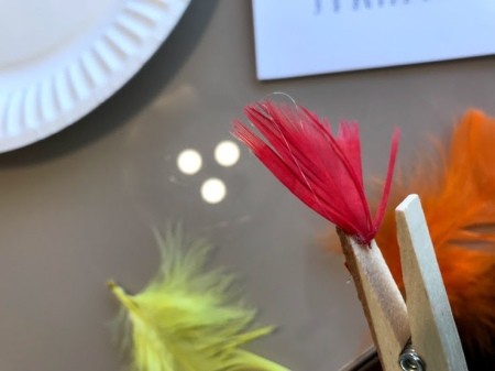 Clothespin Chicken Plant Decoration - glue feathers on the the inside of one of the top parts of the clothespin