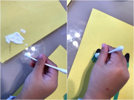 Making a Dandelion Card - Toddler Activity - child applying the paint with a Q-tip