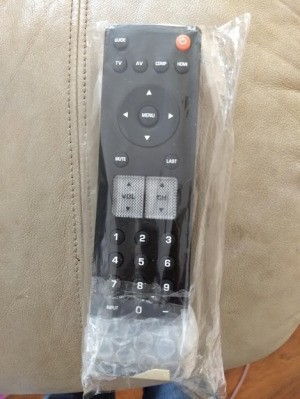 A remote in a plastic bag with bubble wrap on the bottom.