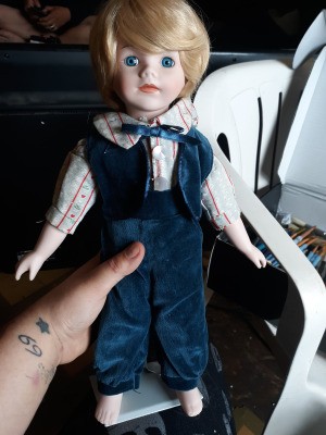 Identifying a Porcelain Doll - doll wearing a blue velvet vest and pants