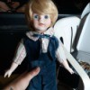 Identifying a Porcelain Doll - doll wearing a blue velvet vest and pants