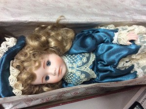 Value of a Dynasty Collection Doll - doll wearing a dark blue satin like dress with lace trim