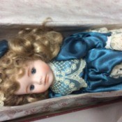 Value of a Dynasty Collection Doll - doll wearing a dark blue satin like dress with lace trim