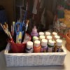 A wicker tissue box used to store paints.