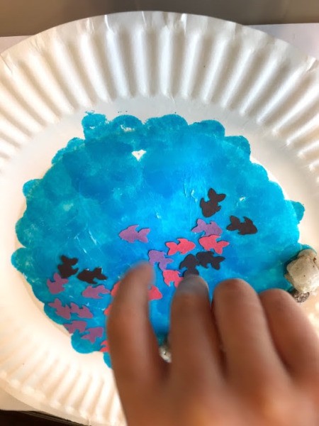 Paper Plate Aquarium Toddler Craft - glue down fish using glue stick