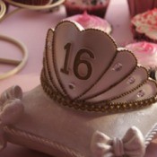 Sweet 16 crown on a pillow shaped cake.