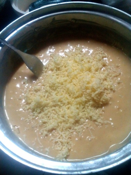 adding grated cheese to batter