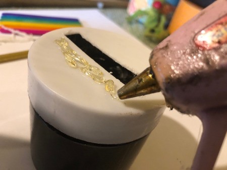 Pot O' Gold Piggy Bank - add blobs of hot glue to the lid around the slot