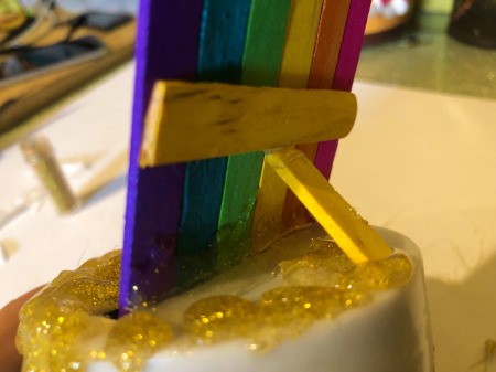 Pot O' Gold Piggy Bank - place the rainbow into the slot diagonally and use a small piece of Popsicle stick to hold it at an angle