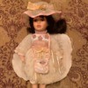 Value of an Unidentified Porcelain Doll - doll wearing a pretty pink dress with a matching hat