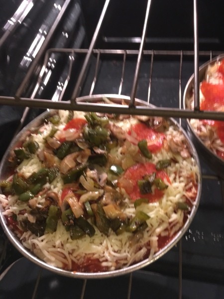 A pizza in the oven before baking.