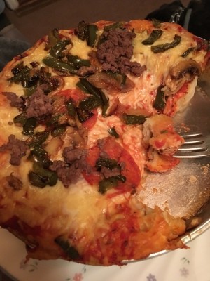 A pan of bubble up pizza with a slice removed.