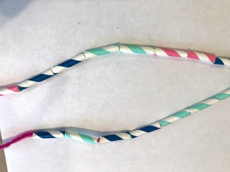 Making a Paper Drinking Straw Snake - twist and fold the pipe cleaner ends when all straw pieces on