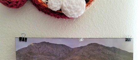 Using binder clips to hold up pages of a thin calendar.