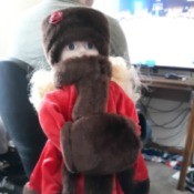 Identifying a Tiffany Russian Porcelain Doll - doll wearing a fur hat, muff, and fur trimmed long red coat