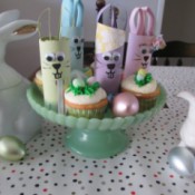 Recycled Bunny Friends - cake plate with bunnies among the cupcakes surrounded by two white ceramic bunnies and plastic eggs