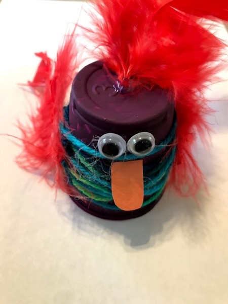 Plastic Cup Pet Bird - beak and top knot feather on purple bird
