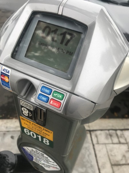 A parking meter with over an hour left on the meter.