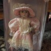 Value of a Collectible Memories Porcelain Doll - doll in pink drop waist period dress with matching hat