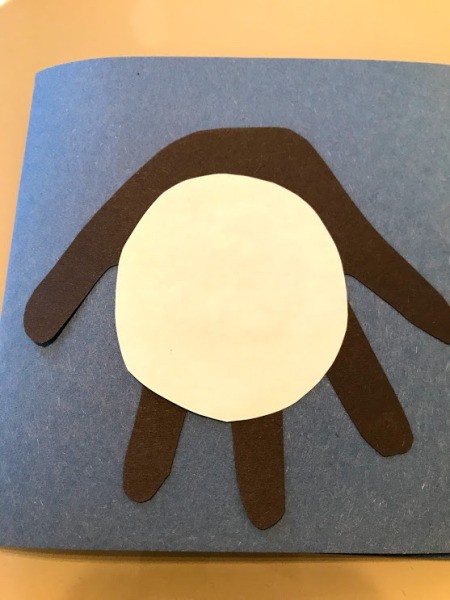 Penguin Handprint Card - cut out a white circle and glue in place