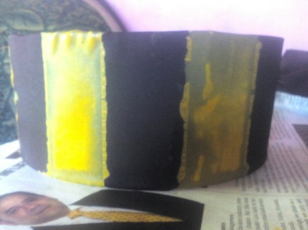 Making an Egyptian Headdress - paint on yellow or gold vertical lines and sprinkle with glitter, set aside