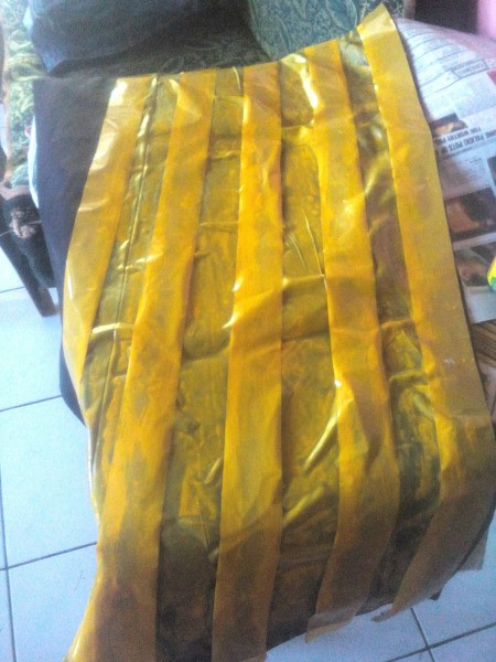 Making an Egyptian Headdress - paint the black spaces between the tape yellow