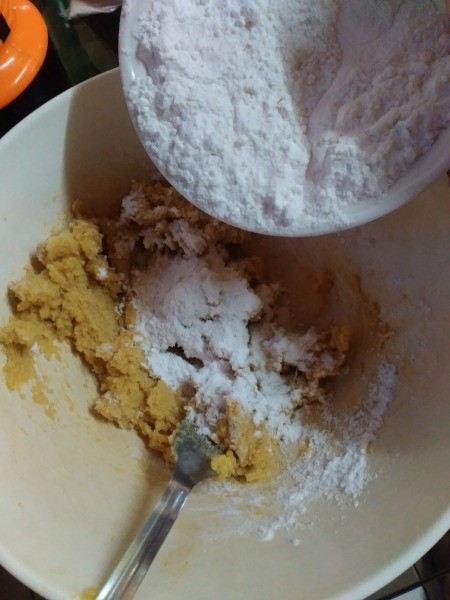 adding flour to batter