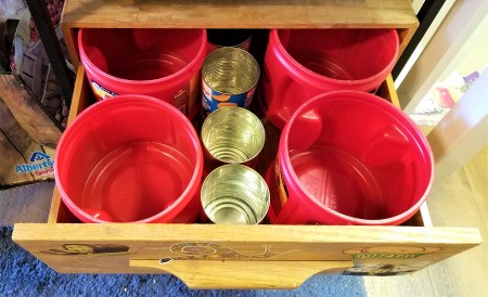 Coffee tubs and other recycled containers being used for organizing tools.