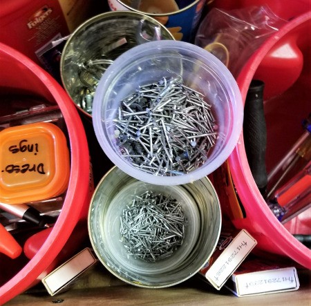 Coffee tubs and other recycled containers being used for organizing tools.