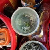 Coffee tubs and other recycled containers being used for organizing tools.