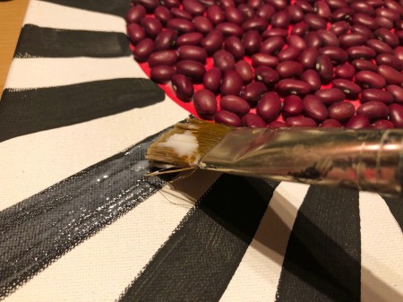 Making a Mural from Beans - add glue to the next section
