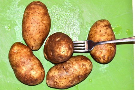 poking potatoes with fork