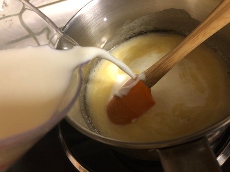adding milk to sauce