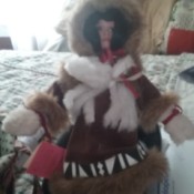 Value of a Paradise Galleries Porcelain Doll - doll wearing Native American clothing