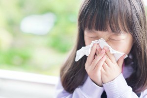 A young girl with a cold or flu.