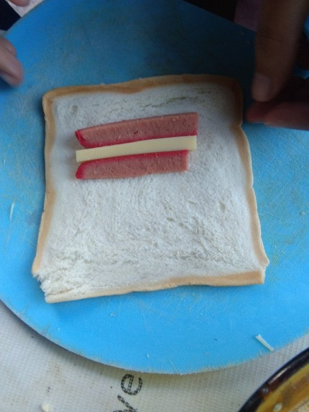 hotdog and cheese strips on bread