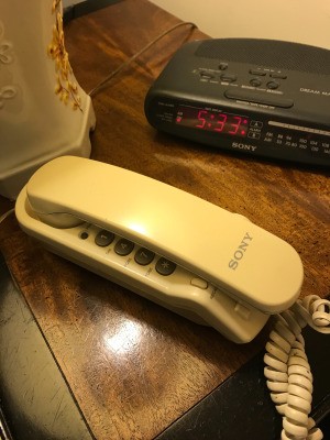 A landline telephone on a nightstand.