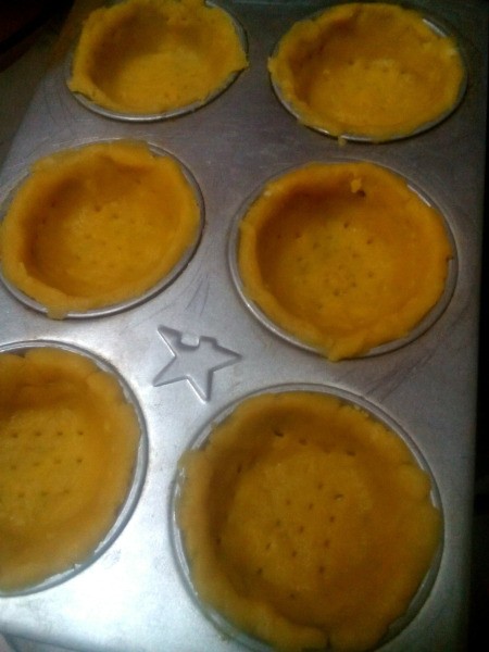 dough in baking pan cups