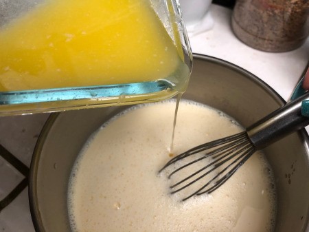 adding melted butter to wet ingredients