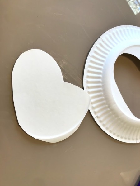 Making a Paper Plate Rainbow  - cut out a cloud shape from a paper plate