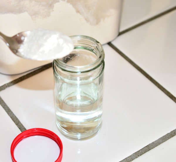 Flour being added to a jar for making gravy.