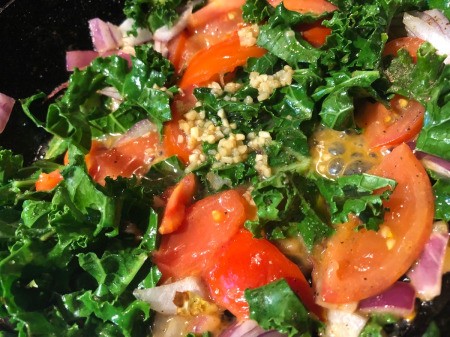 garlic added to vegetables in pan