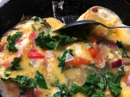 moving cooked egg from the side of pan